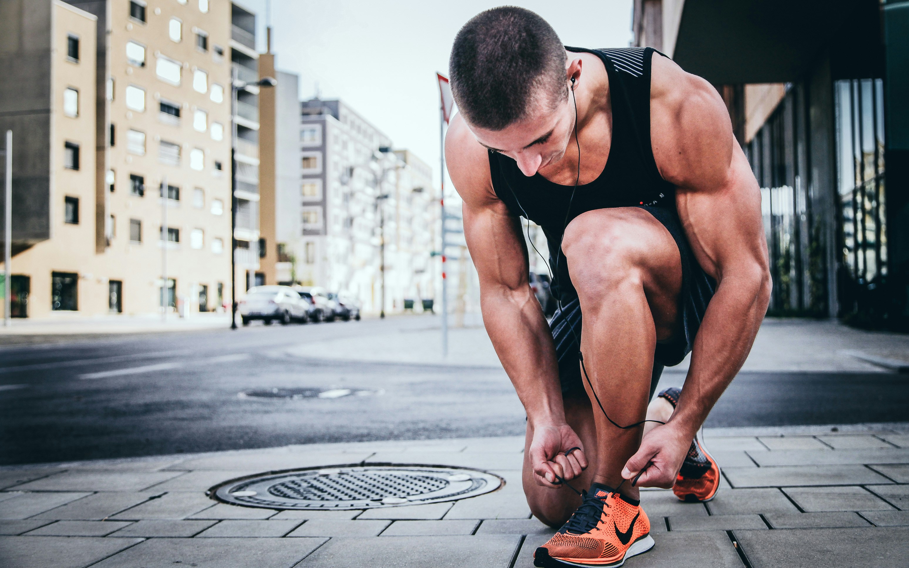 Athletic man tying his shoes - preparation and performance